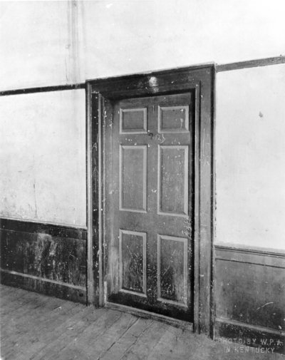 Interior view of the door to the living room of the Ephraim McDowell House prior to renovation by the WPA. Photos by the WPA with handwritten description on back of photo. 8x10