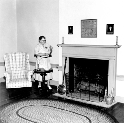 Variant print of photograph by the Lexington Herald-Leader an interior view of  Mrs. Bullock in a bedroom above the living room in the Ephraim McDowell House.   Reprinted March 10, 1954. 8x10 variant print