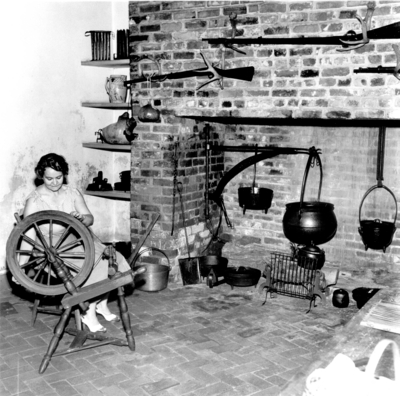 Photograph by the Lexington Herald-Leader an interior view of the kitchen in the Ephraim McDowell House and an unidentified female. A magazine clipping shows comparison to Amstel  House, New Castle, Delaware.  Reprints Sept 4  &  12 1952. 8x10