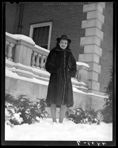 Campus views (1940 Kentuckian) (University of Kentucky); woman                             standing next to a building