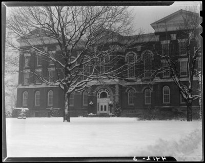 Administration Building (1940 Kentuckian) (University of                             Kentucky); exterior view of building; a cannon monument and a large tree                             reside in front of the building, snow covered