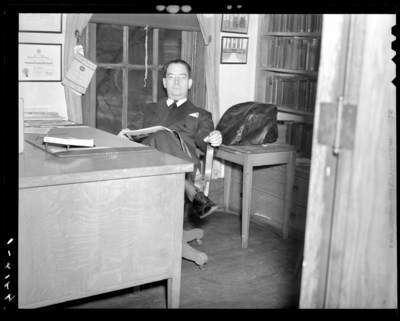 Deans & Professors (1940 Kentuckian) (University of                             Kentucky); man sitting behind a desk with a book in his lap