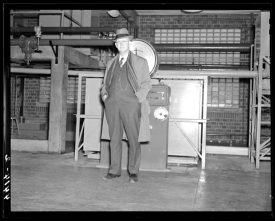 Deans & Professors (1940 Kentuckian) (University of                             Kentucky); interior, man standing in front of equipment