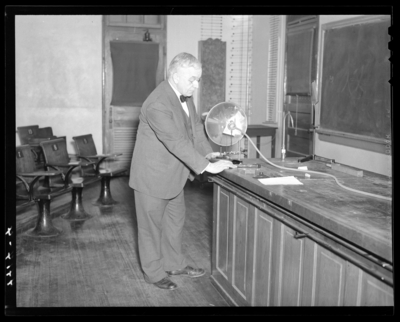 Deans & Professors (1940 Kentuckian) (University of                             Kentucky); man standing next to a lecture hall front demonstration table                             (science)