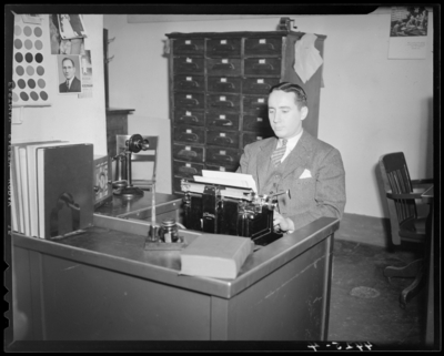 Man at desk using on a typewriter, (1940 Kentuckian) (University                             of Kentucky)