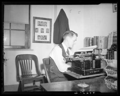 Man at desk using on a typewriter, (1940 Kentuckian) (University                             of Kentucky)