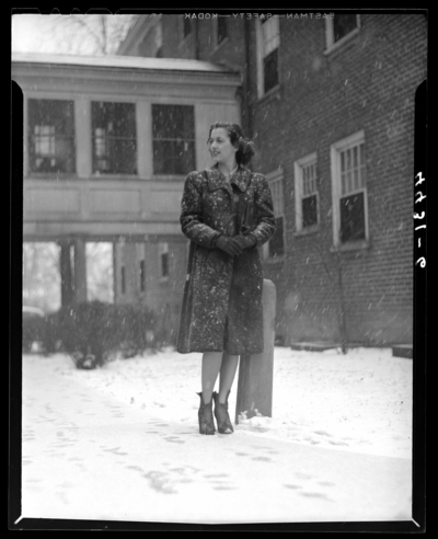 Campus Views (1940 Kentuckian) (University of Kentucky); woman                             standing in front of a building