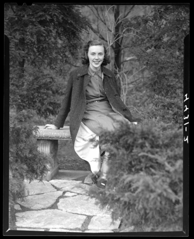 Campus Views (1940 Kentuckian) (University of Kentucky); woman                             sitting on a bench