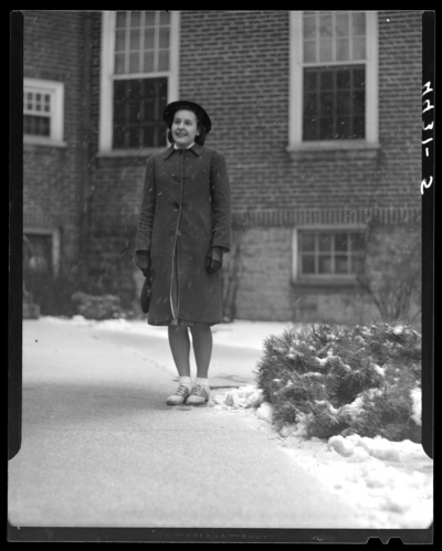 Campus Views (1940 Kentuckian) (University of Kentucky); woman                             standing in front of a building
