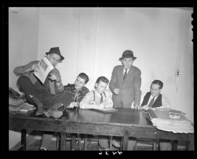 Wildcat Book; cover; group of men sitting around and on a                             table
