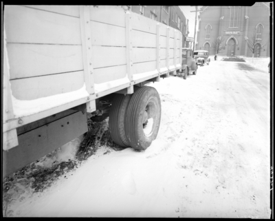 Tires & Machinery; truck parked on the street, close-up                             view of truck's rear tires