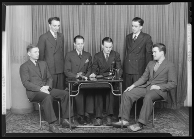 Lenshawks, (1940 Kentuckian) (University of Kentucky); members                             gathered around a table, camera and accessories sitting atop the                             table