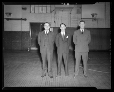 Varsity Basketball, (1940 Kentuckian) (University of Kentucky);                             interior, three coaches standing on the court