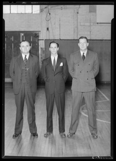 Varsity Basketball, (1940 Kentuckian) (University of Kentucky);                             interior, three coaches standing on the court