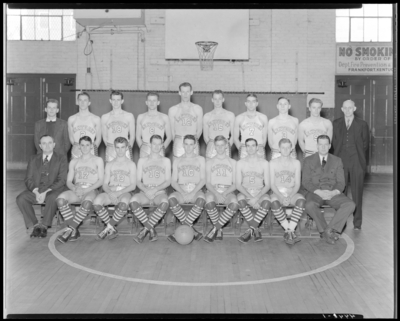 Varsity Basketball, (1940 Kentuckian) (University of Kentucky);                             interior, team group portrait with coaches on the court