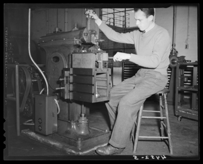 Campus Views (University of Kentucky); interior, man operating a                             piece of machinery