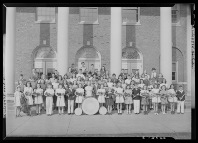Orchestra, Henry Clay High School, 701 East Main; orchestra group                             portrait in front of building, members posing with their                             instruments