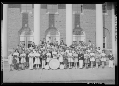 Orchestra, Henry Clay High School, 701 East Main; orchestra group                             portrait in front of building, members posing with their                             instruments