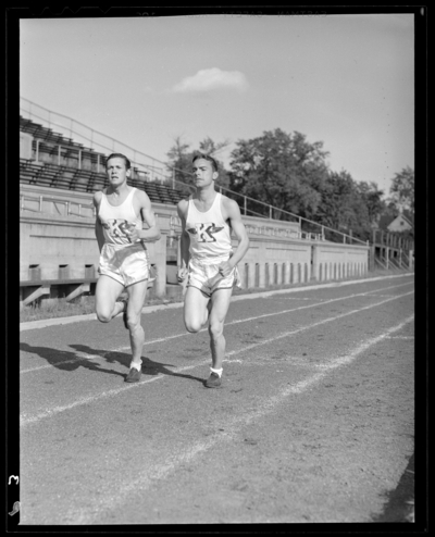 Varsity Track Team, (1941 Kentuckian) (University of Kentucky);                             two team members running on the track