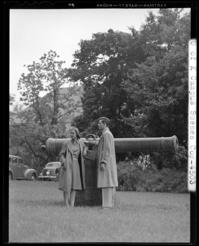 University of Kentucky Campus Scenes, (1941 Kentuckian)                             (University of Kentucky); man and a woman standing next to a                             cannon