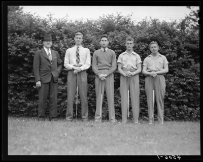 University of Kentucky Varsity Golf Team, (1941 Kentuckian)                             (University of Kentucky); group portrait of team members standing beside                             coach