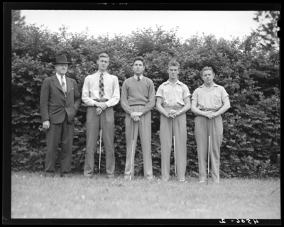 University of Kentucky Varsity Golf Team, (1941 Kentuckian)                             (University of Kentucky); group portrait of team members standing beside                             coach
