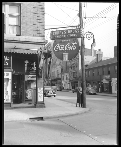 Curry’s Drug Store, 167 West Short (corner of Upper); exterior                             view of store front and nearby buildings; view of the neon sign for                             Coca-Cola products requested by the Coca Cola Company of Louisville,                             Kentucky; L.H. Lewis & Co. Real Estate (150 West Short); Central                             Barber Shop (154 West Short); Milner Hotel (114-118 West Short);                             Rich-Lee Beauty School (124 West Short); Office Equipment Co. (128 West                             Short); American Dry Cleaners (130 West Short); Modern Beauty Shop (134                             West Short); Curry Jas H Restaurant (140 West Short)