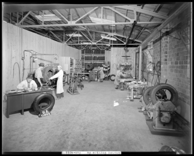United Service Company, 176 East High; interior of shop, workers                             operating machinery and working at a desk