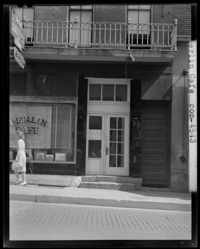 Cafe Berlin, 130-132 North Limestone; exterior of building, woman                             walking past cafe window