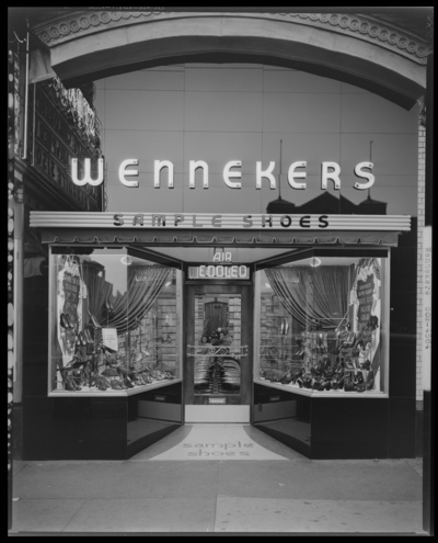 Wenneker Sample Shoe Store, 153 East Main; exterior view of store                             front and window displays, photographed at night