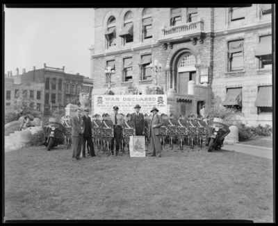 Safety Boy Patrol, Fayette County Patrol (police); Court House                             lawn, group of men and an officer standing with a large group of decoy                             statues (designed to look like boys in officer uniforms) and police                             motorcycles; accident prevention program