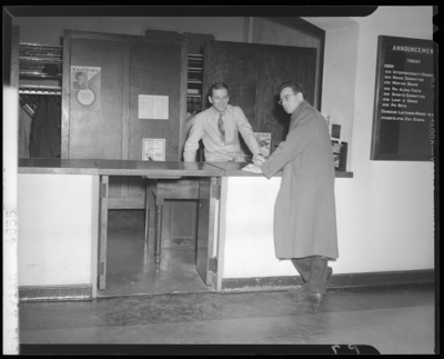 Campus scenes, (1941 Kentuckian) (University of Kentucky); two                             men standing in front of and behind a counter