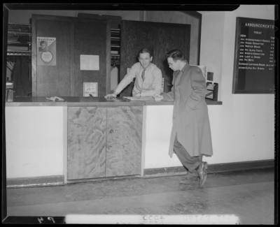 Campus scenes, (1941 Kentuckian) (University of Kentucky); two                             men standing in front of and behind a counter