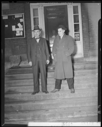 Campus scenes, (1941 Kentuckian) (University of Kentucky); two                             men standing in front of an unidentified building
