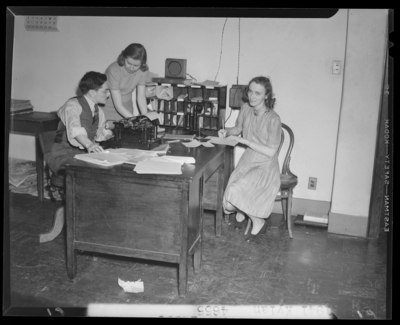 Campus scenes, (1941 Kentuckian) (University of Kentucky); two                             secretaries working next to a man sitting at a typewriter