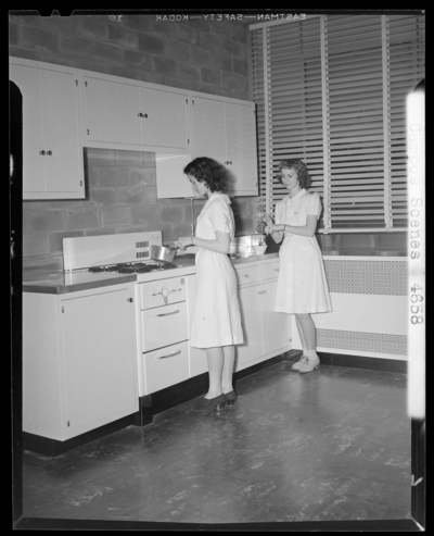 Campus Scenes, (1941 Kentuckian) (University of Kentucky); two                             women working in a Home Economics classroom