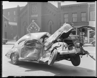 Whaley automobile accident, two damaged (wrecked) cars; OK                             Service Garage (575 West Main), exterior; damaged (wrecked) car                             (vehicle) on tow truck hoist, 1941 Fayette County Kentucky license plate                             number M7053 (no. M7053)