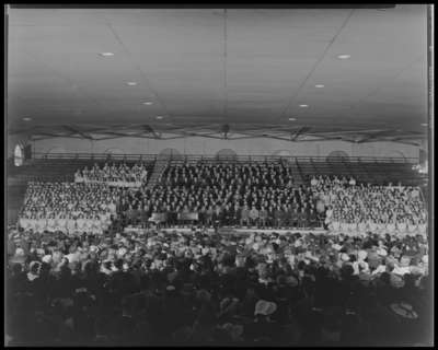 All State Chorus; Men's Gymnasium (Gym), University of                             Kentucky; interior, members sitting in bleachers, audience sitting in                             chairs on the court