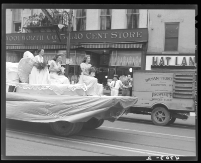 May Day Parade, (1941 Kentuckian) (University of Kentucky); three                             women riding a float down West Main; Woolworth (268 West Main) and Hat                             Land (278 West Main) can be seen in the background