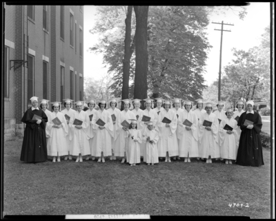 St. Joseph's Hospital, 544 West Second (2nd) Street; Nurses                             graduation; exterior of building, group portrait of nurses holding                             diplomas
