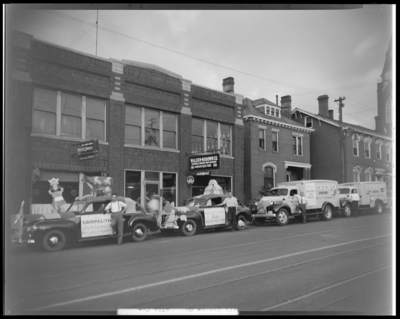Walker-Megown Company (567-569 West Main); Kraft-Phoenix Cheese                             Corporation vehicles (trucks and cars) parked in front of buildings,                             vehicles decorated