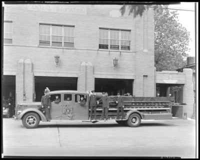 Central Fire Station; Lexington Fire Department; exterior of                             building, fire truck (engine) parked, men standing on truck
