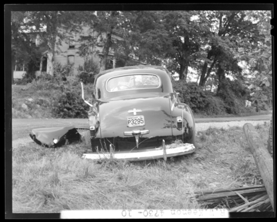 R.W. Keenon, Attorney; accident scene photographs, automobile                             wreck (crash) on Harrodsburg Pike; death (woman, wife); damaged car                             (rear view), 1941 Fayette County Kentucky license plate number P3295                             (no. P3295)