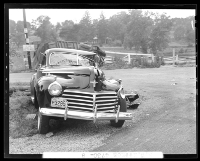 R.W. Keenon, Attorney; accident scene photographs, automobile                             wreck (crash) on Harrodsburg Pike; death (woman, wife); damaged car                             (front view), 1941 Fayette County Kentucky license plate number P3295                             (no. P3295)