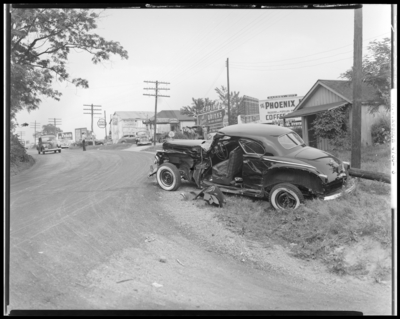 R.W. Keenon, Attorney; accident scene photographs, automobile                             wreck (crash) on Harrodsburg Pike; death (woman, wife); damaged car,                             (side view)
