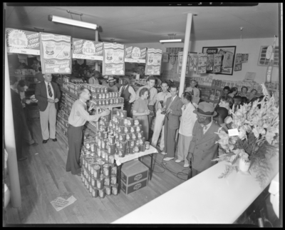MRS Super Market (649 Georgetown); interior, in-store radio                             advertising event; customers shopping, radio host interviewing a                             woman