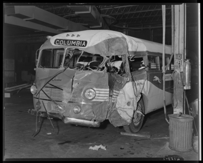 Southeastern Greyhound Lines; interior of garage; wrecked                             (damaged) bus number 803 (no. 803) (Columbia), front view