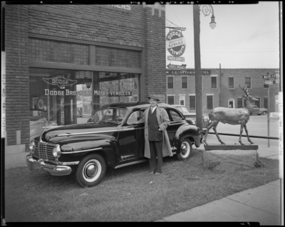 Goodwin Brothers, 444-450 East Main, Dodge Brothers Motor                             Vehicles; exterior of building, man standing next to car