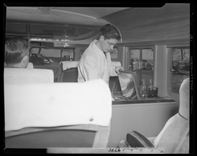 Southeastern Greyhound Lines; coaches, interior of bus, man at                             the refreshment compartment