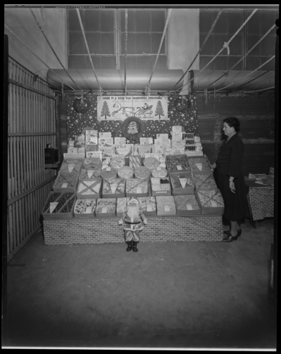 W. T. Sistrunk & Company, 601-603 West High; interior,                             woman standing next to a Christmas candy display